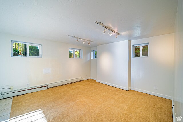 1820 E Redondo Ave S, Salt Lake City, UT 84108 - unfurnished room with rail lighting, light carpet, baseboards, and baseboard heating