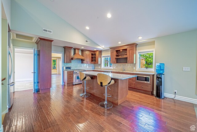 1820 E Redondo Ave S, Salt Lake City, UT 84108 - kitchen featuring appliances with stainless steel finishes, open shelves, wall chimney exhaust hood, brown cabinets, and a sink