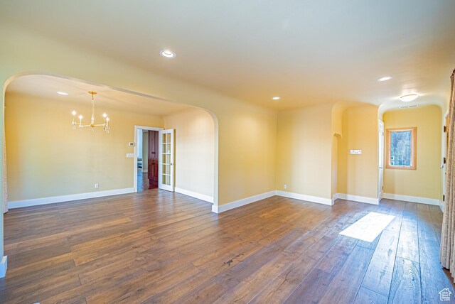 1820 E Redondo Ave S, Salt Lake City, UT 84108 - unfurnished room featuring arched walkways, a chandelier, dark wood-style flooring, recessed lighting, and baseboards