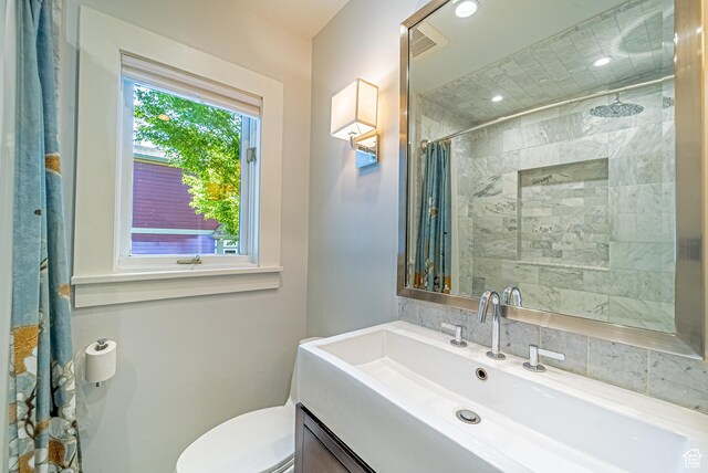 1820 E Redondo Ave S, Salt Lake City, UT 84108 - full bathroom featuring vanity, tiled shower, and toilet