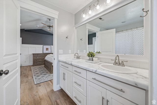 2137 E 170th Cir S, St George, UT 84790 - ensuite bathroom featuring double vanity, a ceiling fan, wood finished floors, and vaulted ceiling