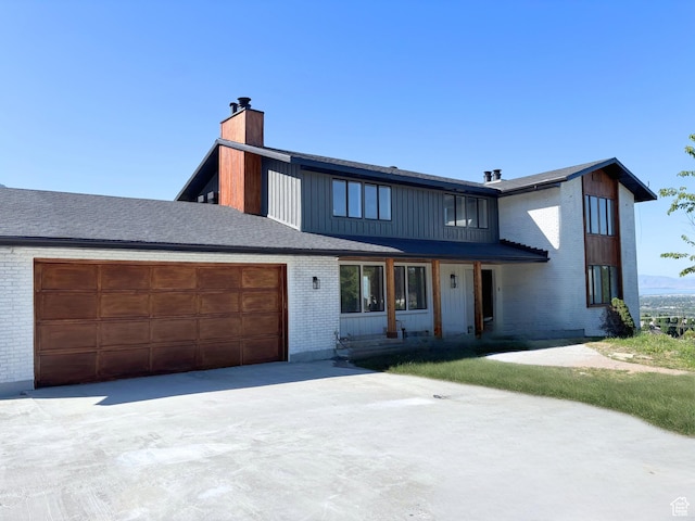 4515 N Norfork Cir, Provo, UT 84604 - modern inspired farmhouse with a chimney, brick siding, an attached garage, and concrete driveway