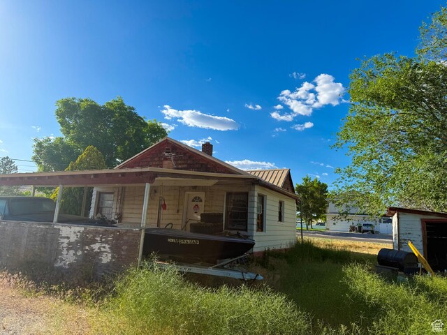 198 N 200 W, Gunnison, UT 84634 - view of front facade with a chimney, metal roof, and a standing seam roof