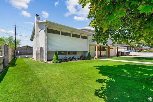 845 N 950 W, Provo, UT 84604 - view of front of house featuring a chimney, a garage, and brick siding