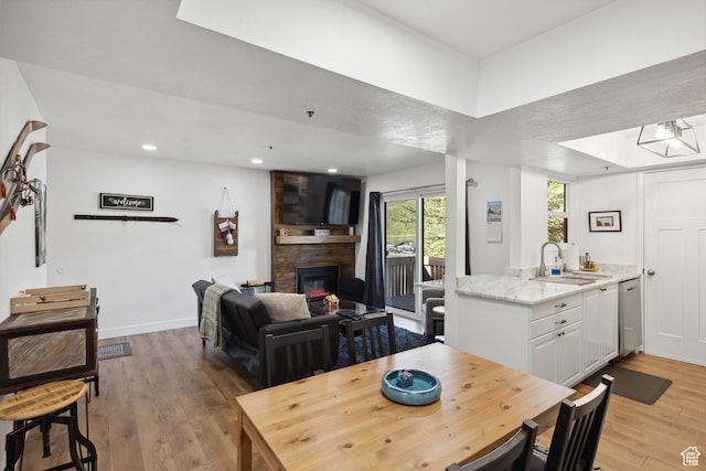7085 N 2200 W Unit 1I, Park City, UT 84098 - dining area with light wood-style floors, a fireplace, recessed lighting, and baseboards