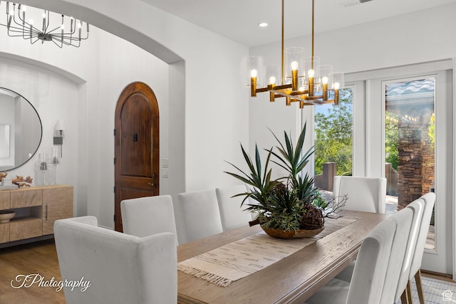 916 E Apache Dr, Washington, UT 84780 - dining area with a chandelier, arched walkways, wood finished floors, and recessed lighting