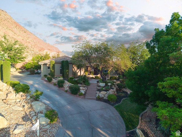916 E Apache Dr, Washington, UT 84780 - view of front of property with a mountain view, stairway, a tile roof, and stucco siding