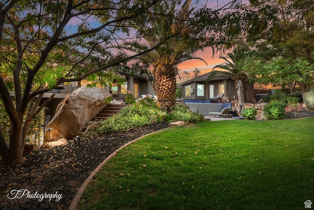 916 E Apache Dr, Washington, UT 84780 - rear view of property featuring a yard, stairway, and stucco siding