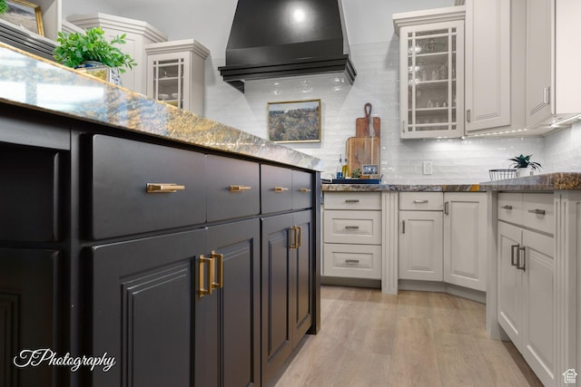 916 E Apache Dr, Washington, UT 84780 - kitchen featuring glass insert cabinets, white cabinets, light wood-style flooring, and exhaust hood