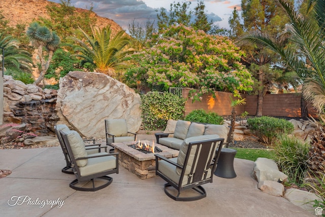 916 E Apache Dr, Washington, UT 84780 - patio terrace at dusk featuring an outdoor fire pit and a patio area