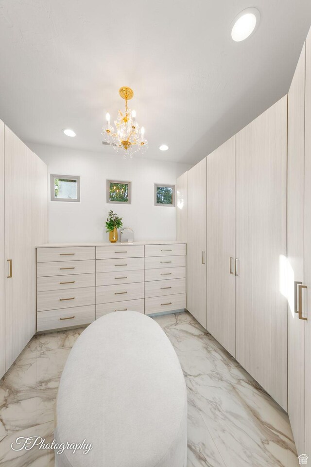 916 E Apache Dr, Washington, UT 84780 - walk in closet featuring light marble finish floors and a chandelier