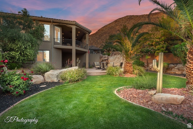 916 E Apache Dr, Washington, UT 84780 - back of property with a balcony, a yard, stucco siding, and a patio area