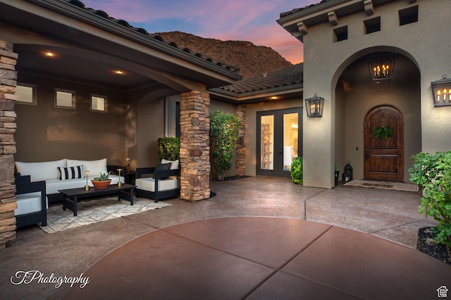 916 E Apache Dr, Washington, UT 84780 - patio terrace at dusk featuring french doors, a patio, and outdoor lounge area