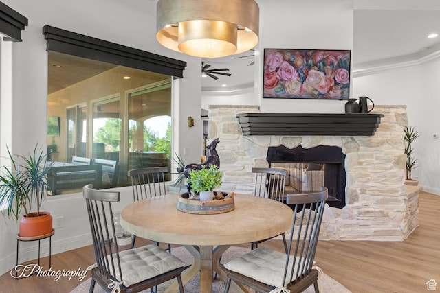 916 E Apache Dr, Washington, UT 84780 - dining space featuring wood finished floors, ceiling fan, a fireplace, baseboards, and ornamental molding