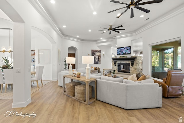 916 E Apache Dr, Washington, UT 84780 - living area with arched walkways, ceiling fan, crown molding, a stone fireplace, and recessed lighting