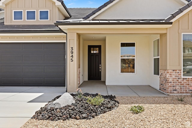 3945 S 2160 W, Hurricane, UT 84737 - view of front of property with board and batten siding, brick siding, a garage, concrete driveway, and stucco siding