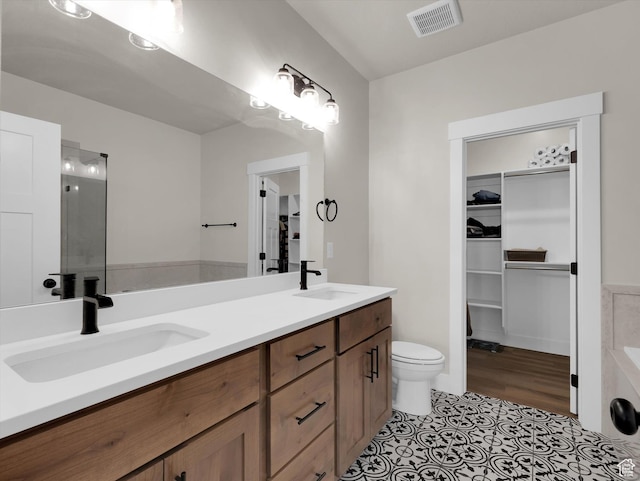 3425 W Isabel Way, West Haven, UT 84401 - full bathroom featuring double vanity, a walk in closet, toilet, an enclosed shower, and tile patterned floors