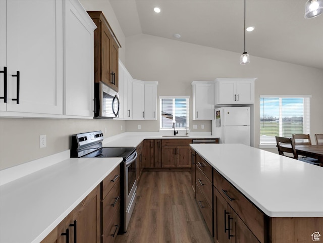 3425 W Isabel Way, West Haven, UT 84401 - kitchen with appliances with stainless steel finishes, lofted ceiling, a sink, dark wood-style flooring, and plenty of natural light