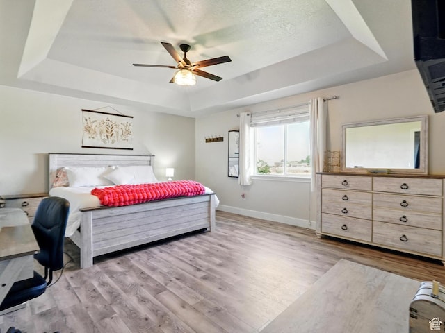 2699 N 3475 W, Plain City, UT 84404 - bedroom featuring a raised ceiling, light wood-type flooring, baseboards, and ceiling fan