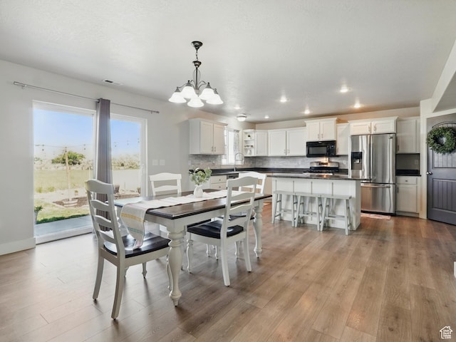 2699 N 3475 W, Plain City, UT 84404 - dining space featuring a chandelier, wood finished floors, and recessed lighting