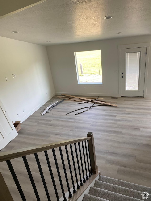 4618 W 75 N Unit 404, West Point, UT 84015 - stairs with wood finished floors, baseboards, and a textured ceiling