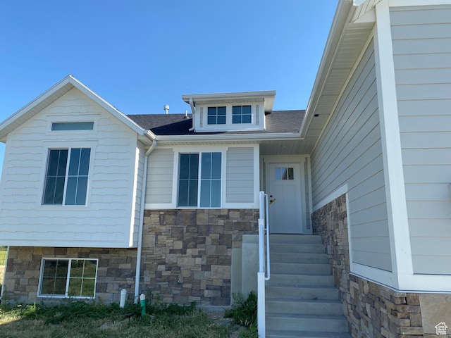 4618 W 75 N Unit 404, West Point, UT 84015 - doorway to property with stone siding and a shingled roof
