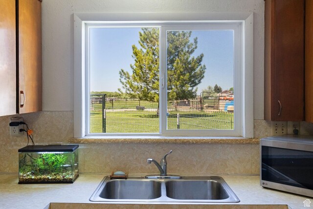 1435 W 600 S, Logan, UT 84321 - kitchen with stainless steel microwave, light countertops, a sink, and tasteful backsplash
