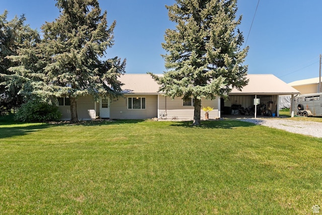 1435 W 600 S, Logan, UT 84321 - back of house with gravel driveway, metal roof, a lawn, and a carport