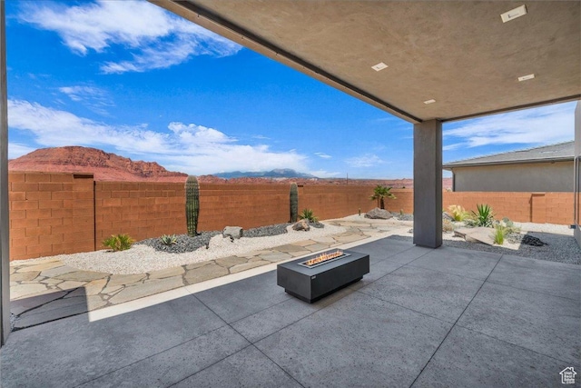 133 E Terrace Ln, Ivins, UT 84738 - fenced backyard featuring a fire pit, a patio, and a mountain view