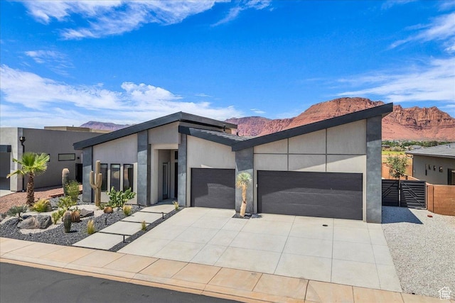 133 E Terrace Ln, Ivins, UT 84738 - contemporary home featuring an attached garage, a mountain view, driveway, stucco siding, and a gate