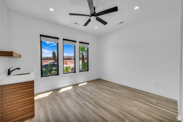 133 E Terrace Ln, Ivins, UT 84738 - empty room featuring light wood-style flooring, ceiling fan, a sink, baseboards, and recessed lighting