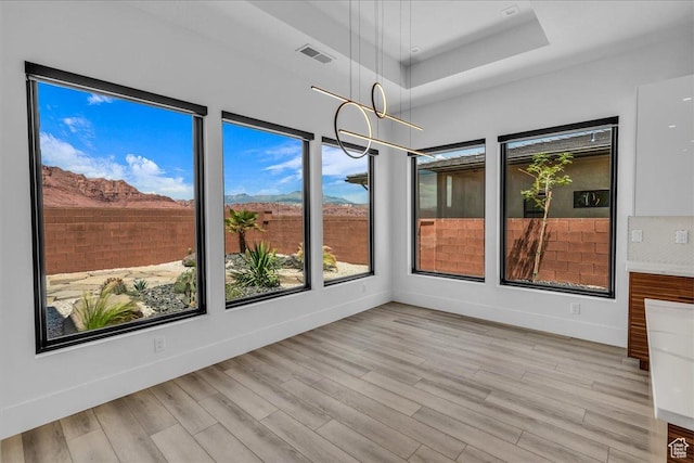 133 E Terrace Ln, Ivins, UT 84738 - unfurnished sunroom featuring a raised ceiling, healthy amount of natural light, and wood finished floors