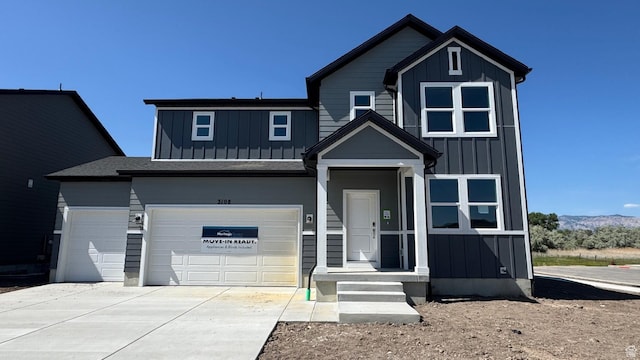 3108 W 3450 S Unit 0155, West Haven, UT 84401 - view of front of house with board and batten siding, driveway, a garage, and a mountain view