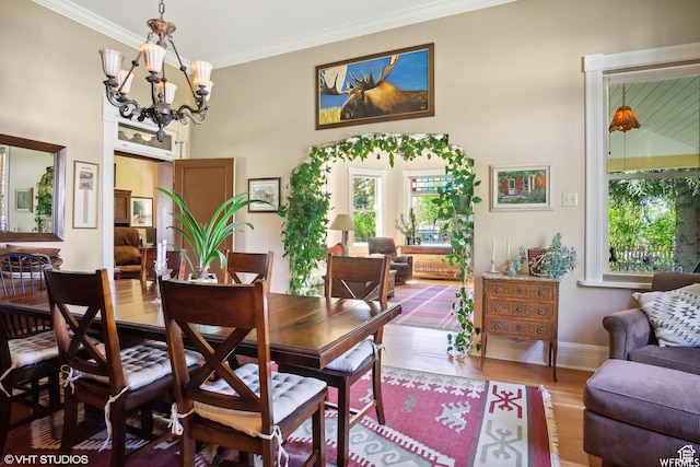 211 E 100 N, Midway, UT 84049 - dining room featuring plenty of natural light, crown molding, wood finished floors, a chandelier, and baseboards