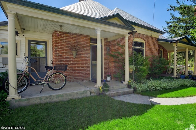 211 E 100 N, Midway, UT 84049 - doorway to property featuring brick siding, a porch, and a lawn