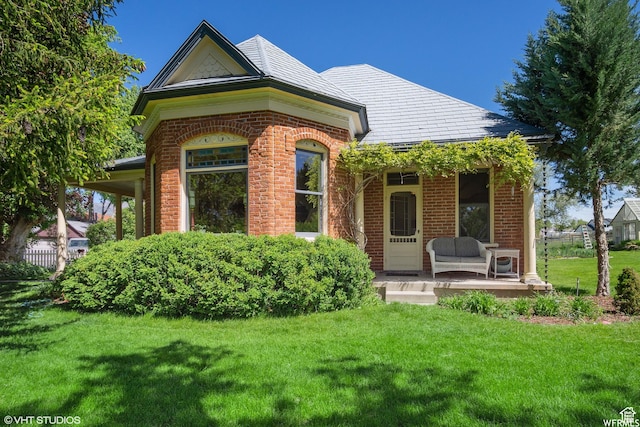 211 E 100 N, Midway, UT 84049 - view of exterior entry with brick siding, a lawn, and covered porch