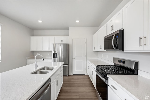 3129 W 3450 S Unit 0171, West Haven, UT 84401 - kitchen featuring appliances with stainless steel finishes, white cabinetry, light stone countertops, dark wood finished floors, and recessed lighting