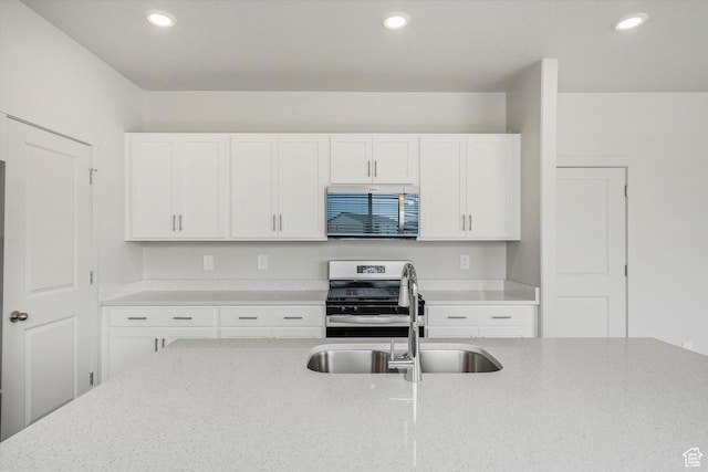3129 W 3450 S Unit 0171, West Haven, UT 84401 - kitchen featuring appliances with stainless steel finishes, white cabinetry, light stone countertops, and recessed lighting