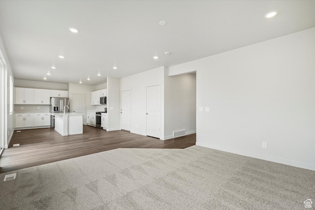3129 W 3450 S Unit 0171, West Haven, UT 84401 - unfurnished living room featuring carpet, recessed lighting, and wood finished floors