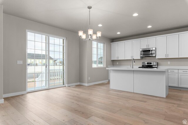 2616 N 3020 W, Clinton, UT 84015 - kitchen with appliances with stainless steel finishes, baseboards, light countertops, a chandelier, and recessed lighting