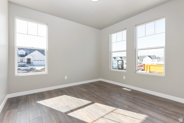 6564 N Bald Unit D195, Eagle Mountain, UT 84005 - unfurnished room featuring dark wood finished floors and baseboards