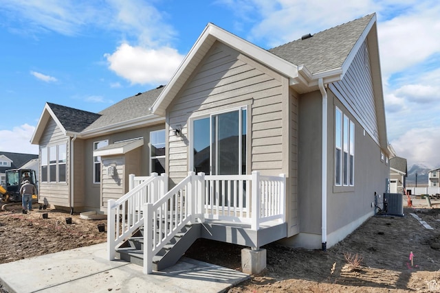6564 N Bald Unit D195, Eagle Mountain, UT 84005 - back of house featuring central AC, a shingled roof, and a patio area