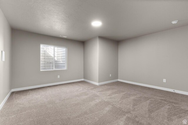6564 N Bald Unit D195, Eagle Mountain, UT 84005 - carpeted spare room with baseboards, a textured ceiling, and a smoke detector