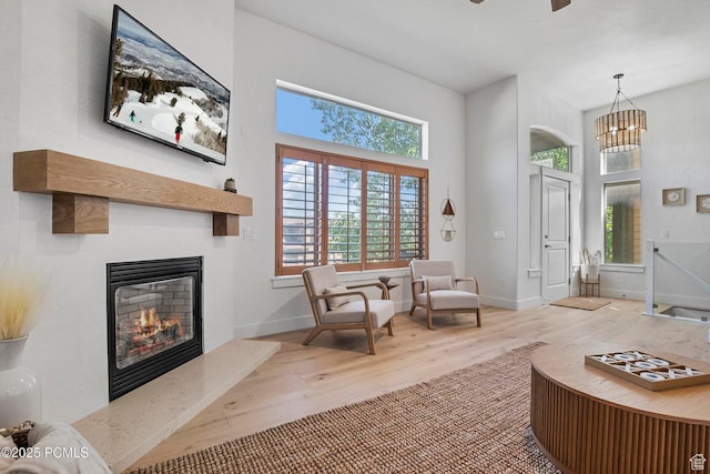 5521 N Freestyle Way, Park City, UT 84098 - living area featuring wood finished floors, plenty of natural light, baseboards, a glass covered fireplace, and a high ceiling