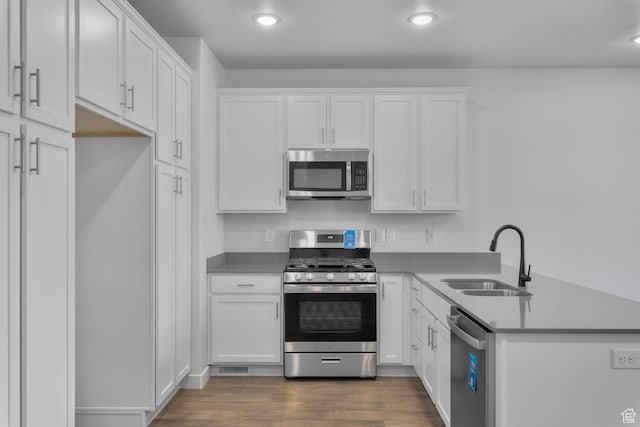 1822 N 180 E, Heber City, UT 84032 - kitchen with appliances with stainless steel finishes, a sink, white cabinets, a peninsula, and recessed lighting