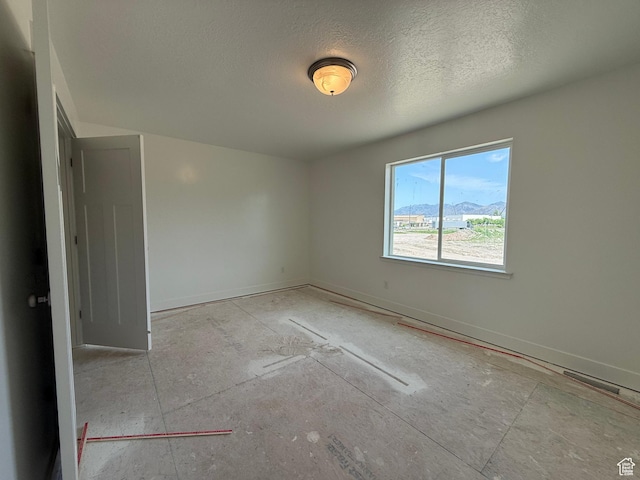 3298 S 1000 W, Nibley, UT 84321 - unfurnished room featuring a textured ceiling and baseboards