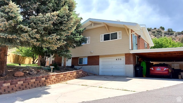 470 E Parkway Dr, Cedar City, UT 84721 - view of front facade with concrete driveway, an attached garage, brick siding, and a carport