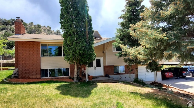 470 E Parkway Dr, Cedar City, UT 84721 - view of front facade featuring brick siding, a front lawn, and a chimney