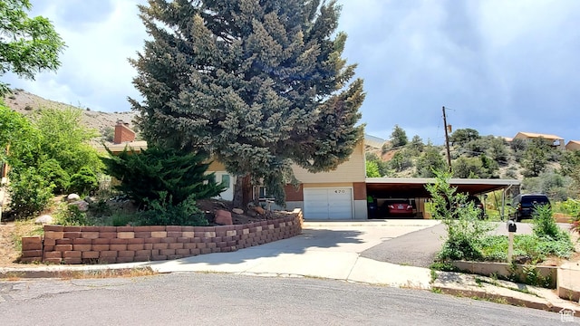 470 E Parkway Dr, Cedar City, UT 84721 - view of property hidden behind natural elements featuring an attached garage, driveway, and a carport