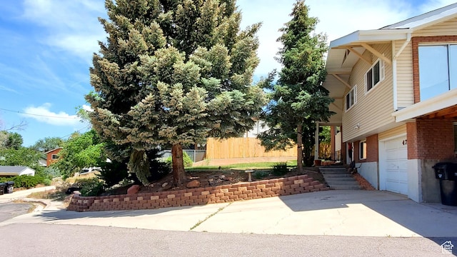 470 E Parkway Dr, Cedar City, UT 84721 - view of home's exterior with an attached garage, driveway, and brick siding